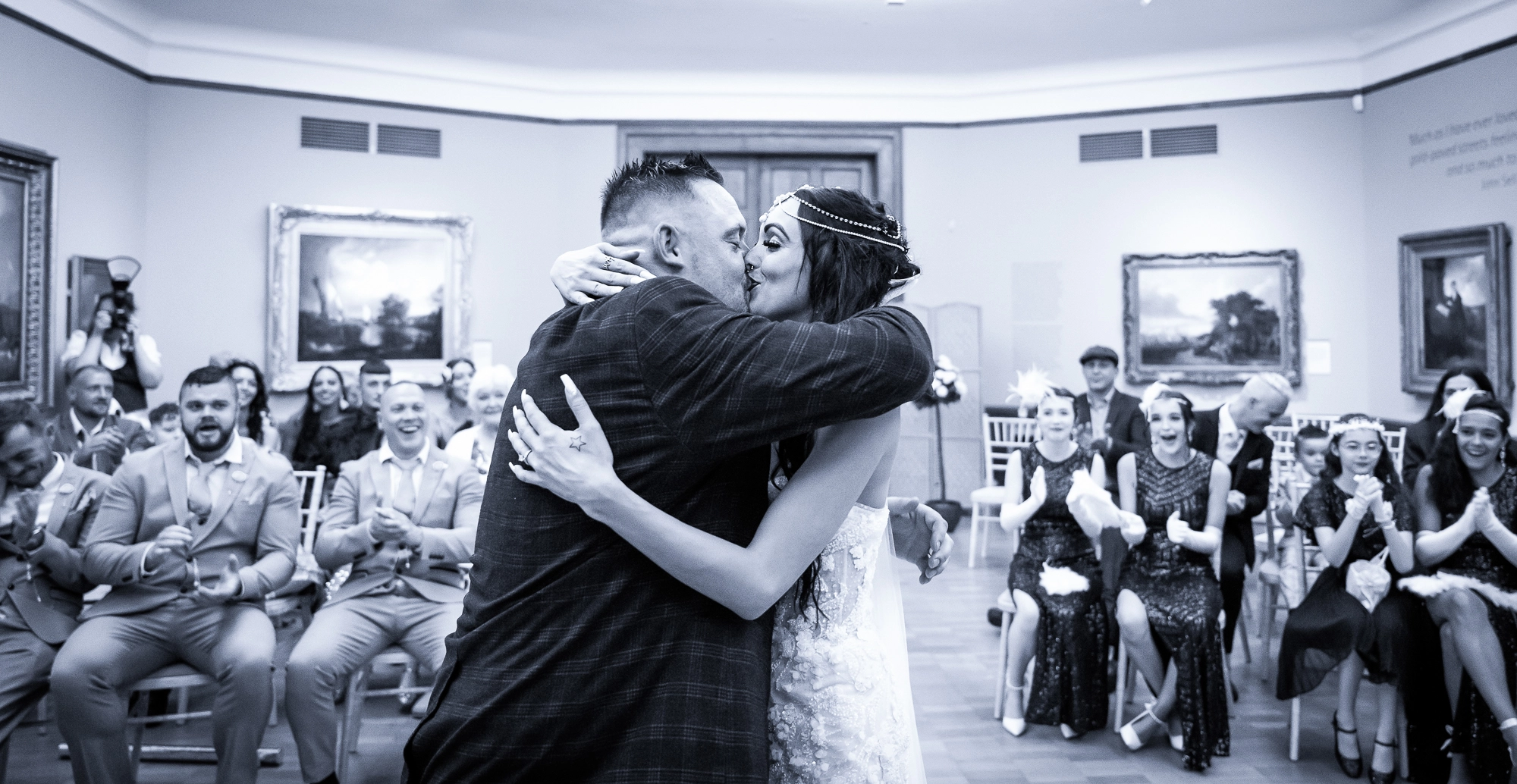 Black & White image of a couple kissing as they've just got married