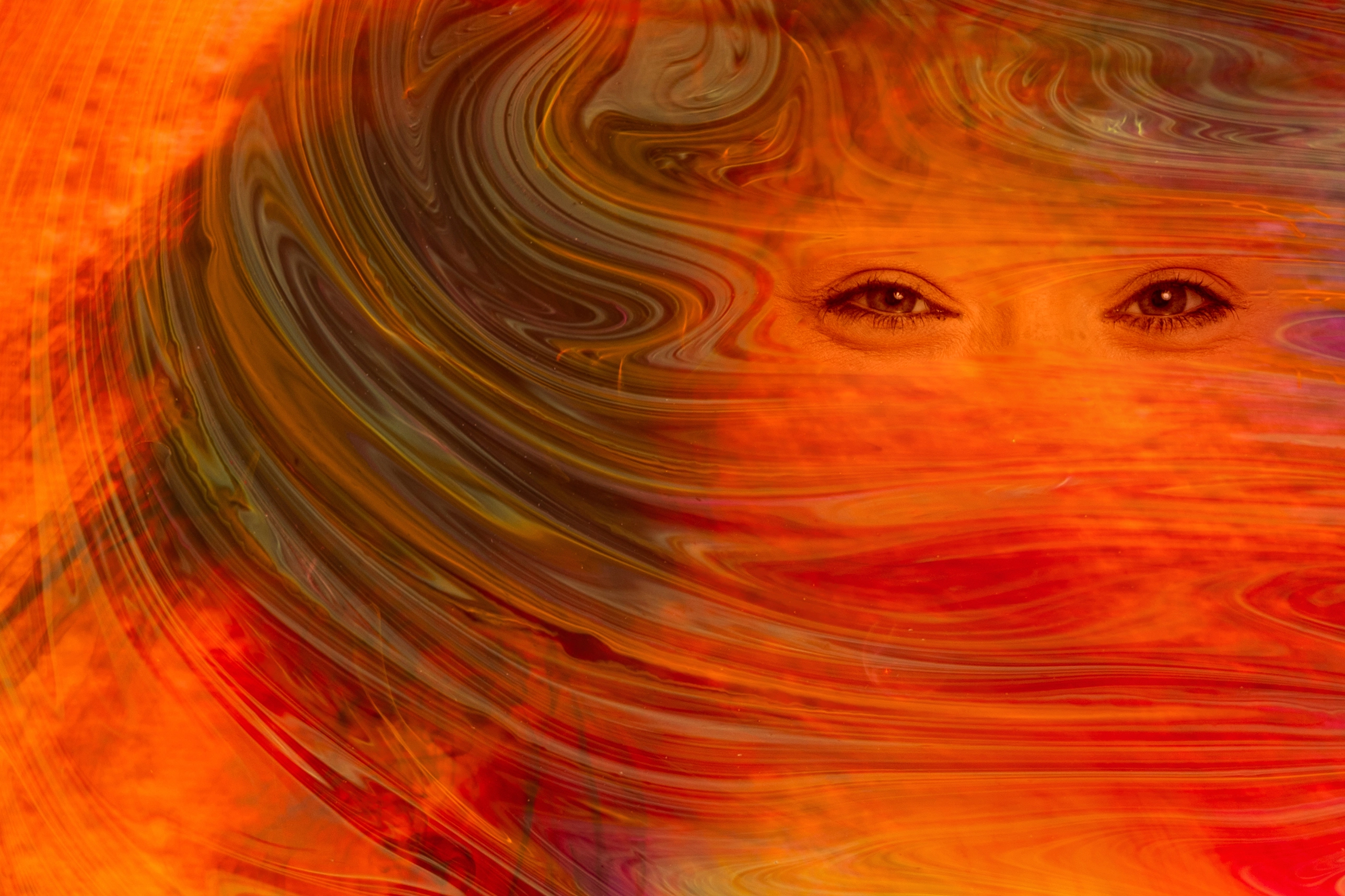 Red tones Art image with smiling eyes looking