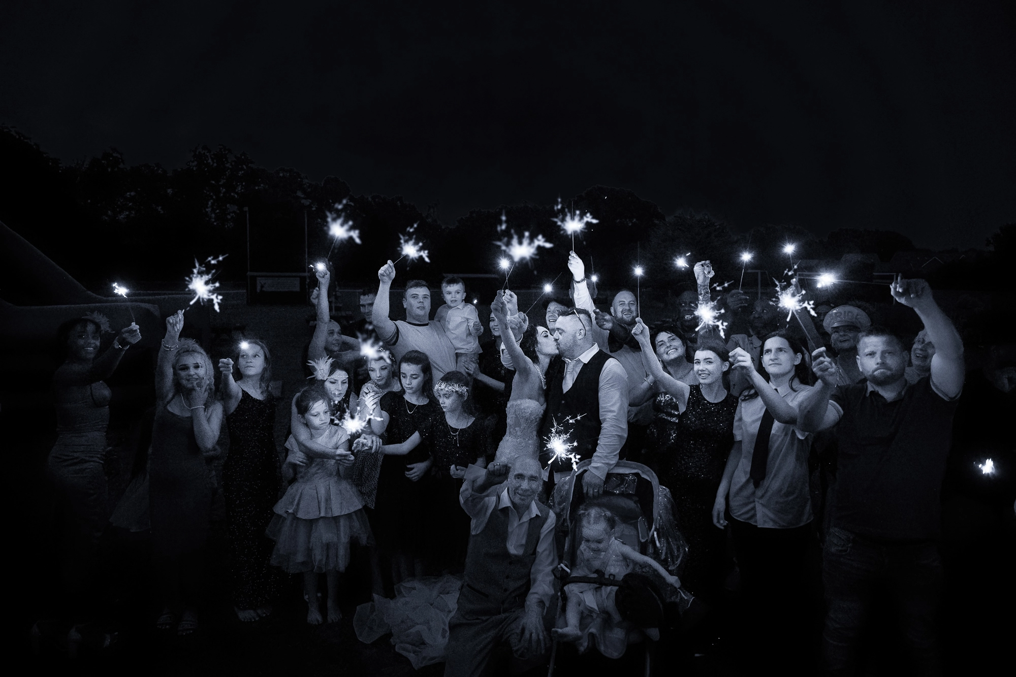 Wedding guests at night with sparklers